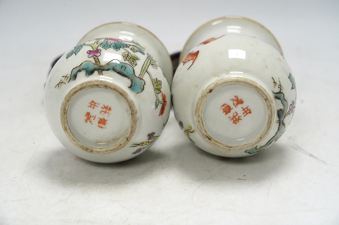 A pair of Chinese famille rose vases, mid 20th century, on wood stands, 10cm high. Condition - good